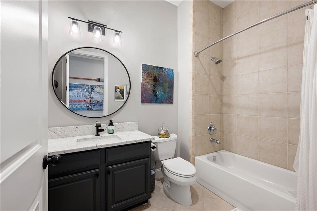 360 Chambers Street, Unit 407 Woodstock, GA 30188 - Photo 29 of 62 a bathroom with a toilet a sink and a mirror