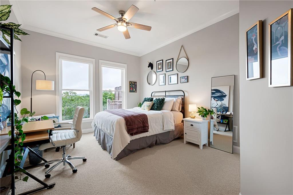 360 Chambers Street, Unit 407 Woodstock, GA 30188 - Photo 30 of 62 a bed room with a bed and a chandelier