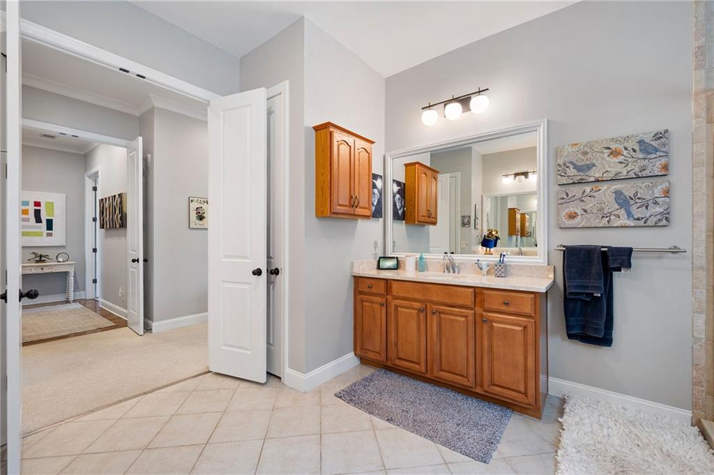 360 Chambers Street, Unit 407 Woodstock, GA 30188 - Photo 35 of 62 a spacious bathroom with a mirror sink and shower