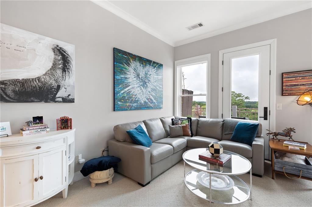 360 Chambers Street, Unit 407 Woodstock, GA 30188 - Photo 40 of 62 a living room with furniture and a large window