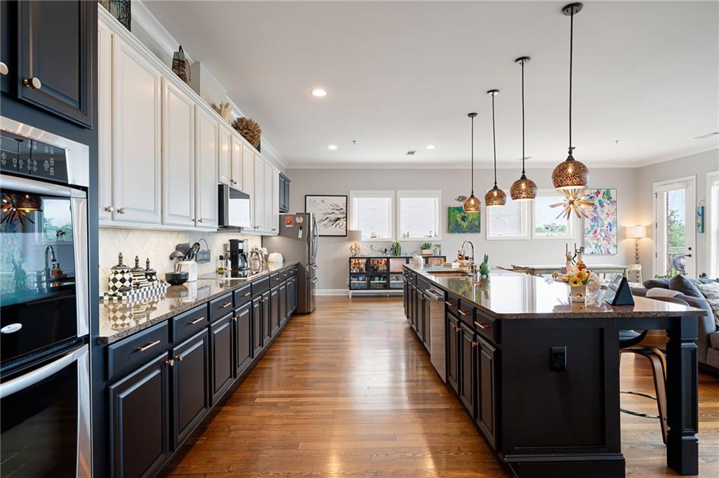 360 Chambers Street, Unit 407 Woodstock, GA 30188 - Photo 4 of 62 a kitchen with kitchen island granite countertop lots of counter top space