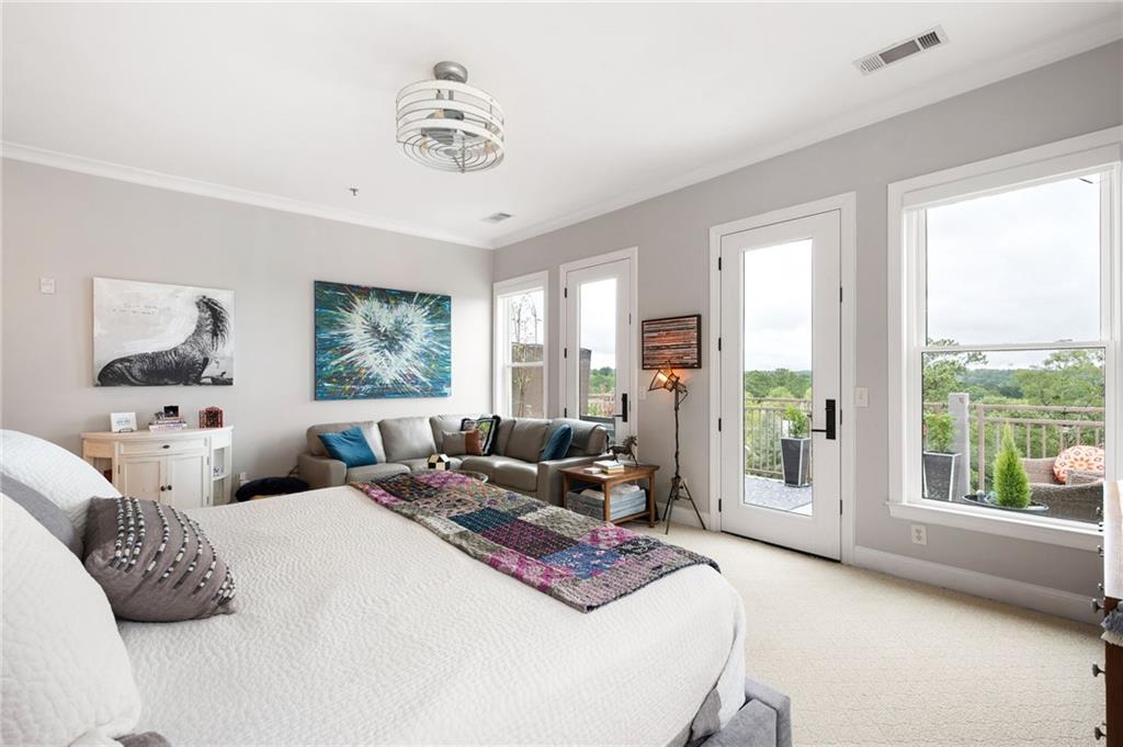 360 Chambers Street, Unit 407 Woodstock, GA 30188 - Photo 42 of 62 a bedroom with a bed and glass window