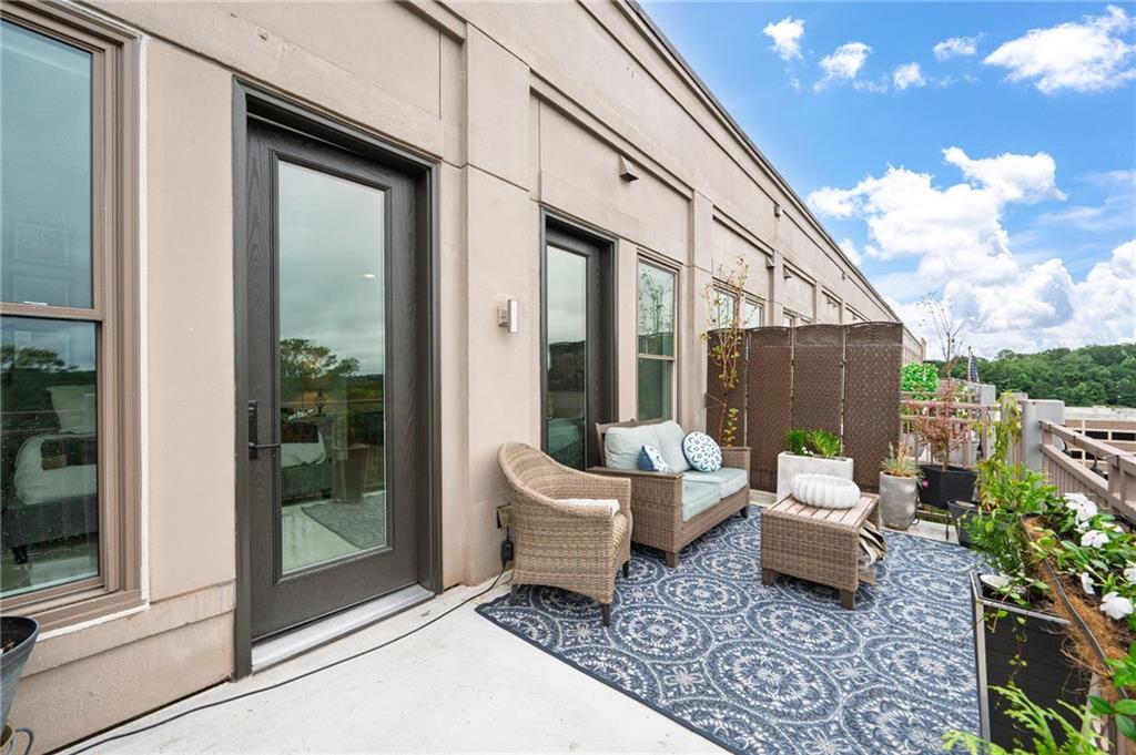 360 Chambers Street, Unit 407 Woodstock, GA 30188 - Photo 45 of 62 a outdoor space with patio the couch and glass door