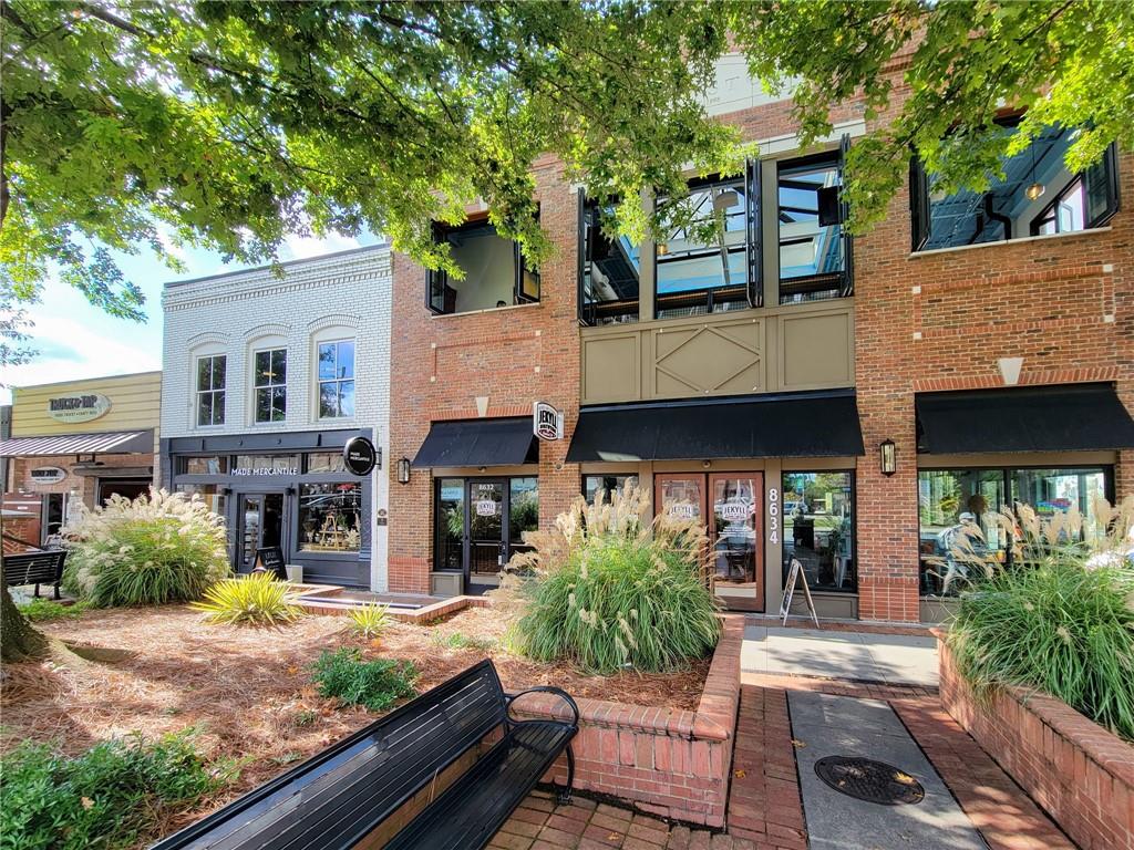 360 Chambers Street, Unit 407 Woodstock, GA 30188 - Photo 58 of 62 a view of a house with a porch and furniture