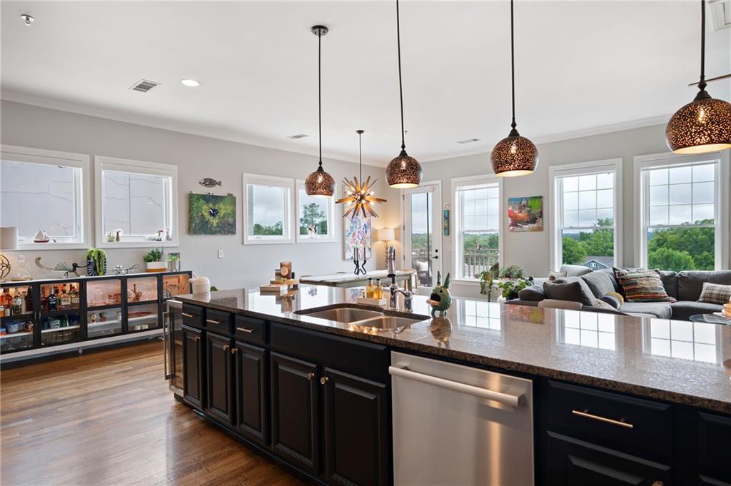 360 Chambers Street, Unit 407 Woodstock, GA 30188 - Photo 6 of 62 a kitchen with lots of counter top space and wooden floor