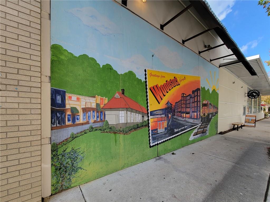 360 Chambers Street, Unit 407 Woodstock, GA 30188 - Photo 62 of 62 a front view of a house with a yard and potted plants