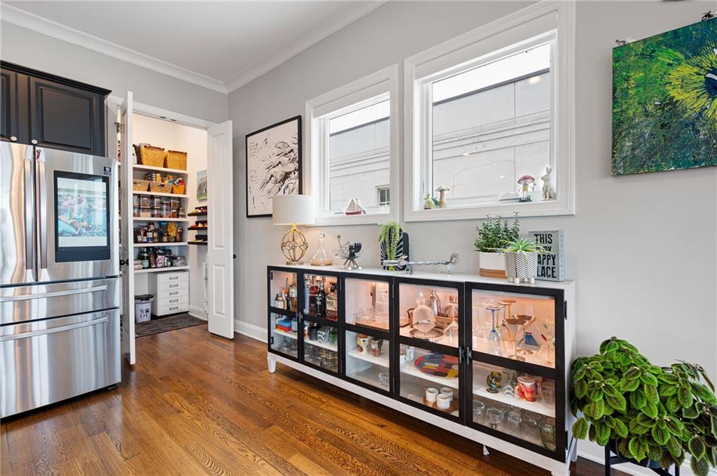 360 Chambers Street, Unit 407 Woodstock, GA 30188 - Photo 7 of 62 a kitchen with stainless steel appliances wooden cabinets and a window