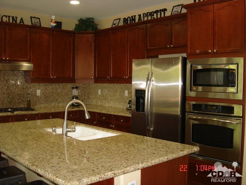 83436 Lightning Road Indio, CA 92203 - Photo 9 of 23 a kitchen with kitchen island a sink refrigerator and stove