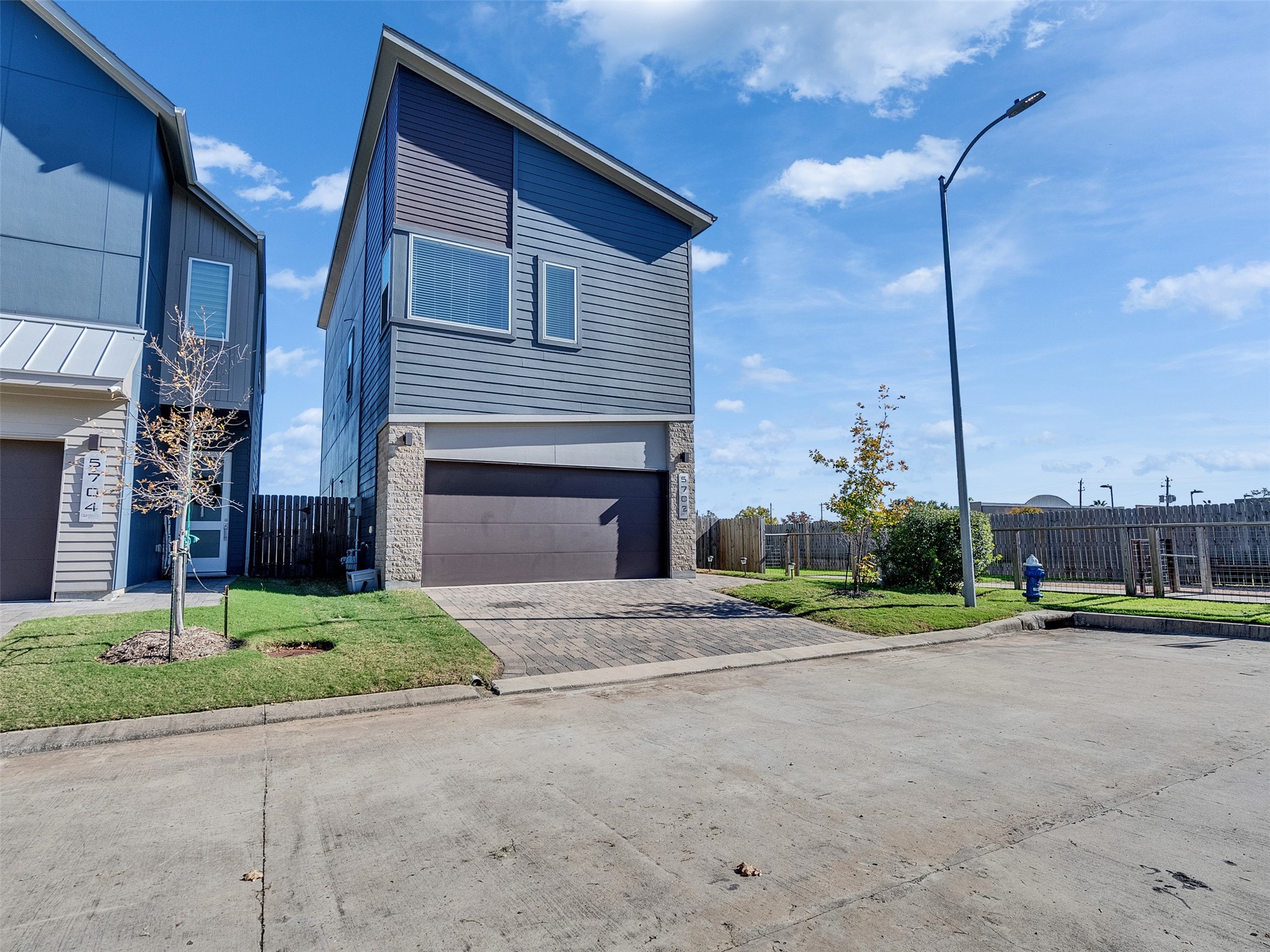 5702 Rucio Lane Houston, TX 77092 - Photo 2 of 30 a front view of a house with a yard and garage