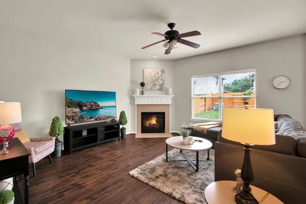 a living room with furniture a fireplace and a flat screen tv