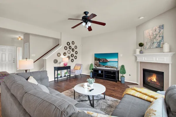 a living room with furniture a fireplace and a table