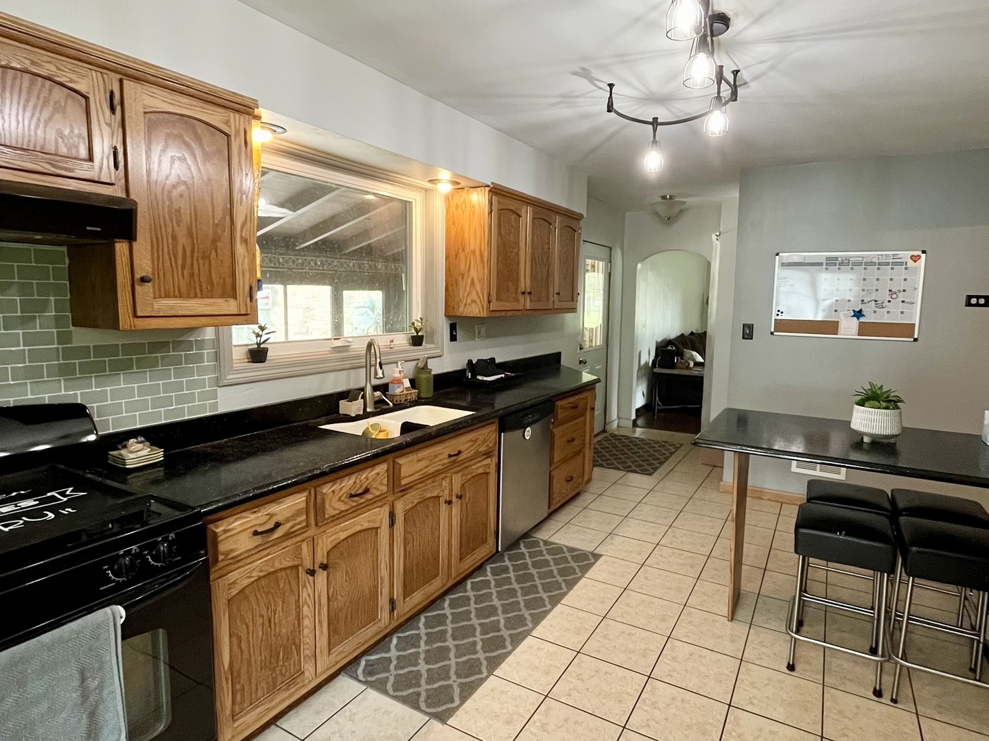 1010 Black Road Joliet, IL 60435 - Photo 5 of 17 a kitchen with stainless steel appliances granite countertop a stove a sink a counter space and cabinets