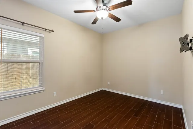a view of a room with wooden floor and fan