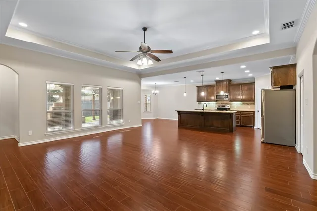 a view of a kitchen with a stove wooden floor and a kitchen