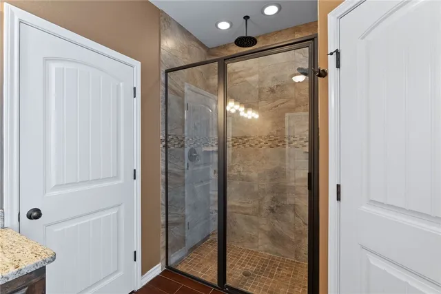 a bathroom with a glass shower door