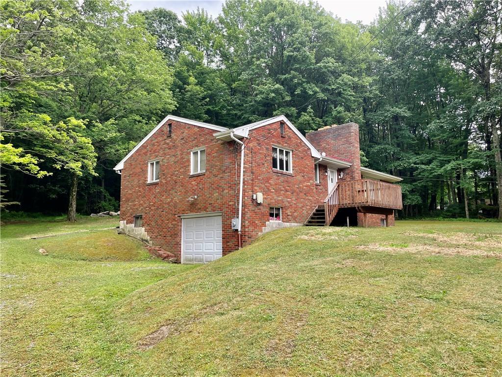 156 County Line Road Acme, PA 15610 - Photo 14 of 19 a front view of a house with a garden
