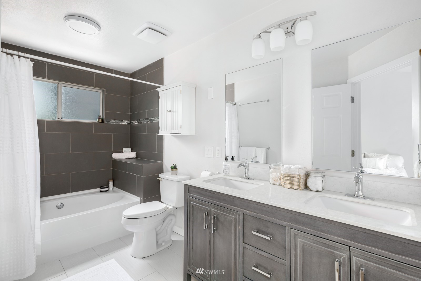 901 South 32nd Street Renton, WA 98055 - Photo 19 of 32 a bathroom with a double vanity sink toilet mirror and bathtub