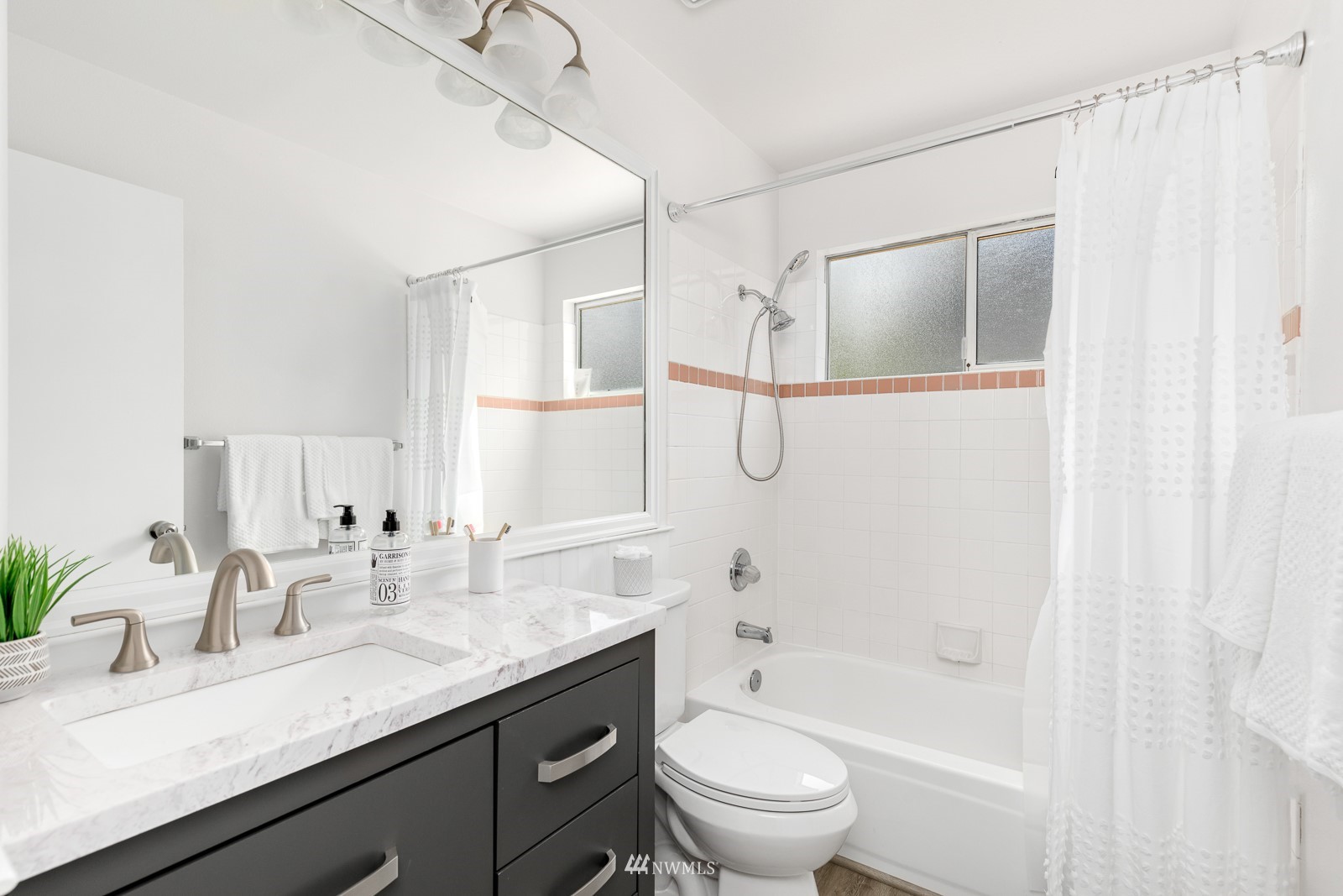 901 South 32nd Street Renton, WA 98055 - Photo 22 of 32 a bathroom with a granite countertop sink a toilet and shower