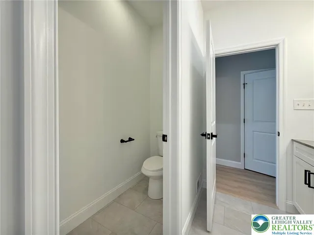 a en suite bathroom with a granite countertop sink and a mirror