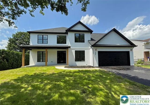 a front view of a house with a yard and garage