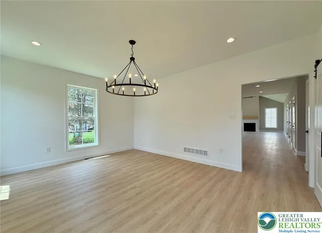 a kitchen with stainless steel appliances granite countertop a sink and a refrigerator