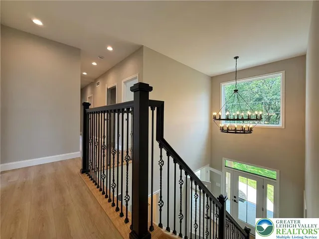 a view of an empty room window and wooden floor