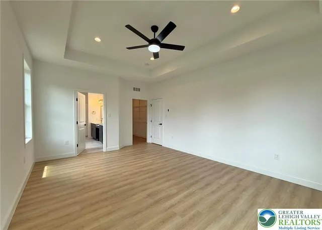 a spacious bathroom with a bathtub sink and mirror