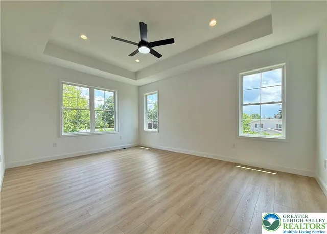 a white bath tub sitting in a bathroom next to a window