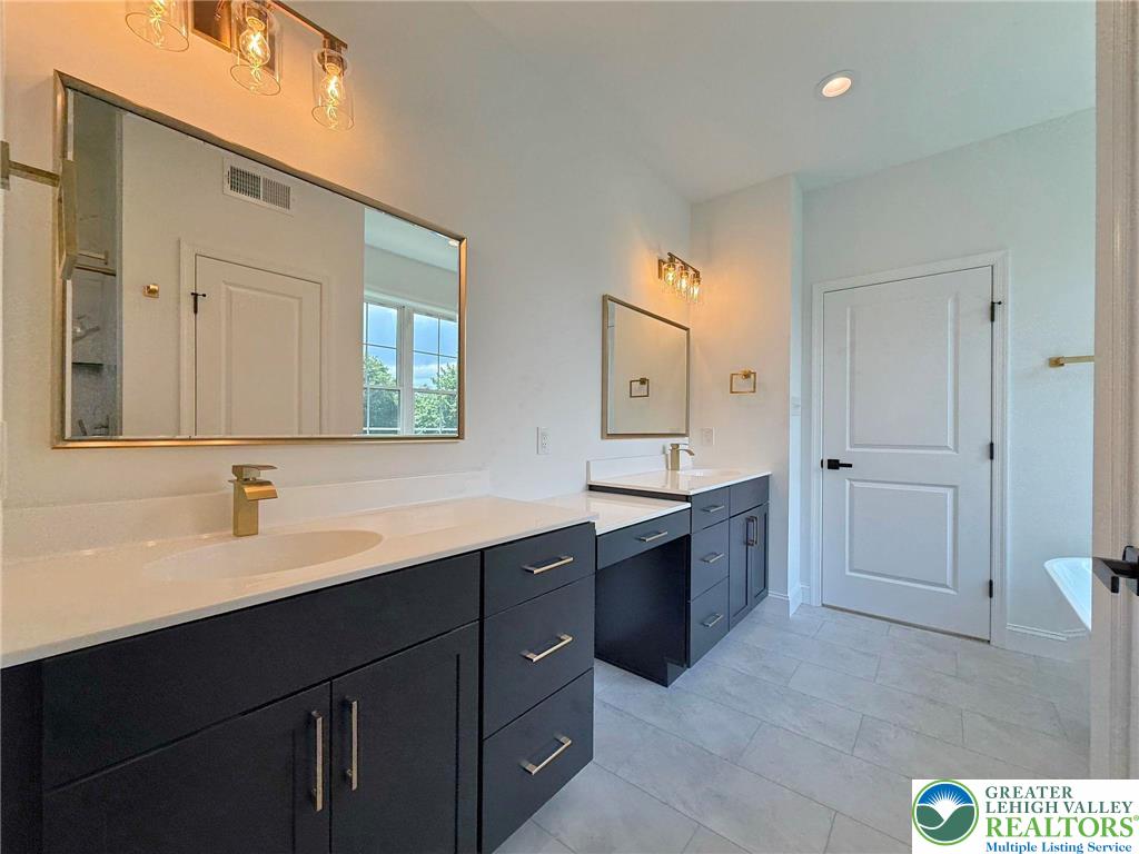 Strauss Lane, Unit 1 Bethlehem, PA 18015 - Photo 47 of 56 a spacious bathroom with a bathtub sink and mirror