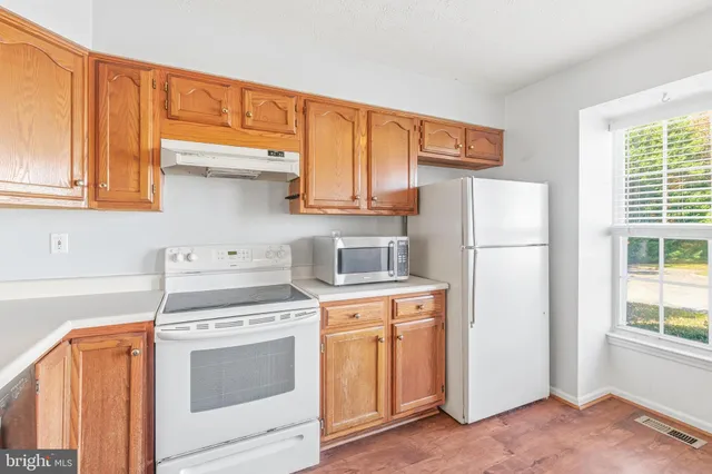 a kitchen with appliances a sink and a cabinets