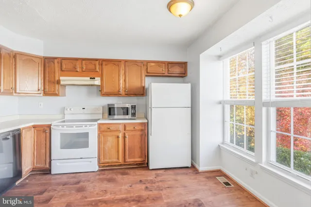 a kitchen with a stove a sink and a refrigerator