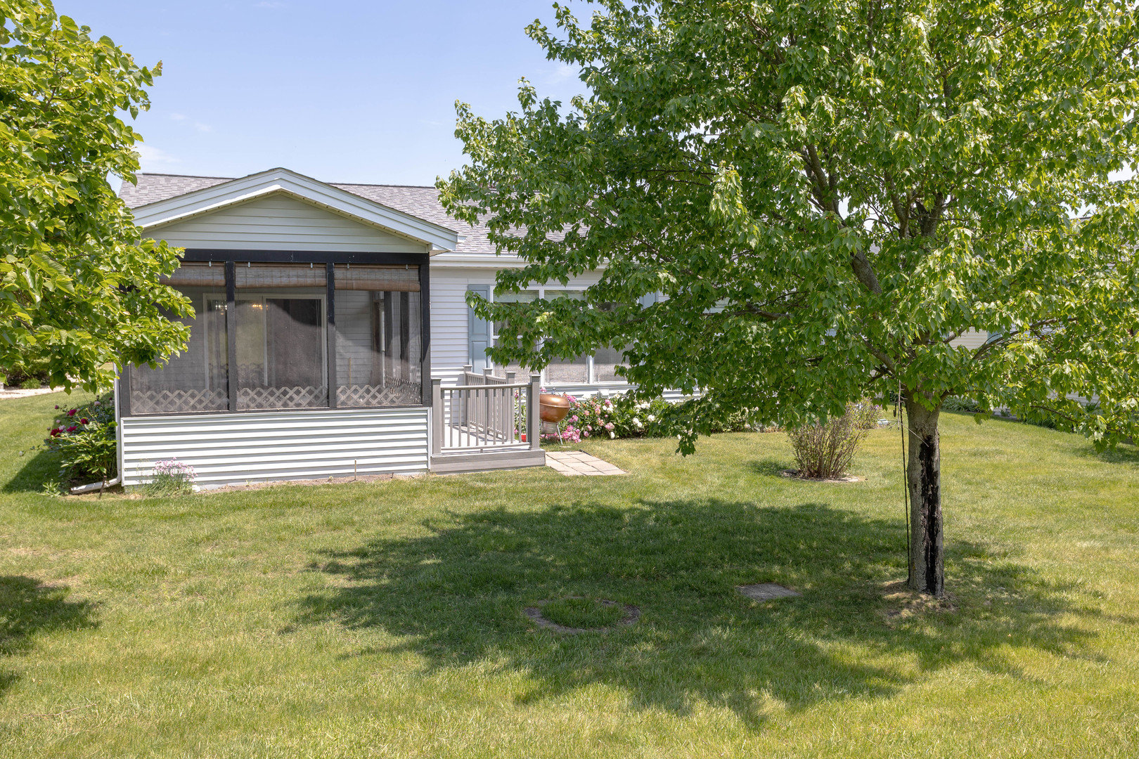 212 Rodeo Drive, Unit 2179 Grayslake, IL 60030 - Photo 4 of 31 a view of a house with a small yard plants and tree