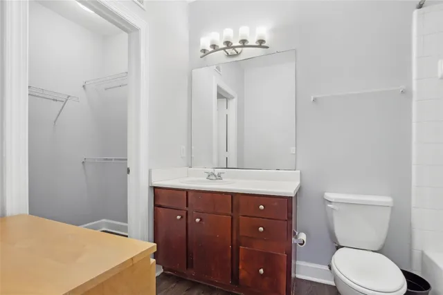 a bathroom with a toilet a sink and mirror