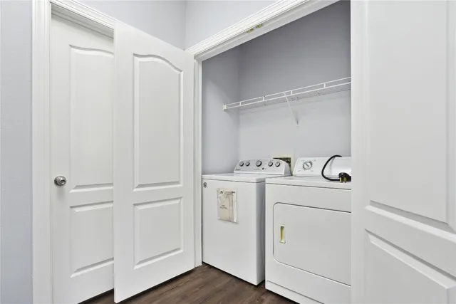 a utility room with cabinets washer and dryer