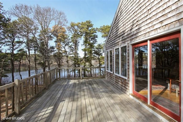 1020 Samoset Road Eastham, MA 02642 - Photo 12 of 16 a view of backyard with large trees and wooden floor