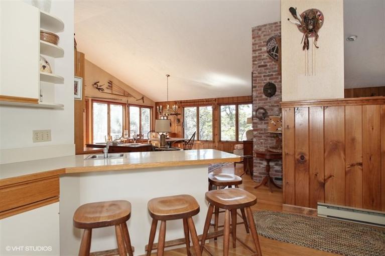 1020 Samoset Road Eastham, MA 02642 - Photo 6 of 16 a kitchen with stainless steel appliances a table and chairs in it