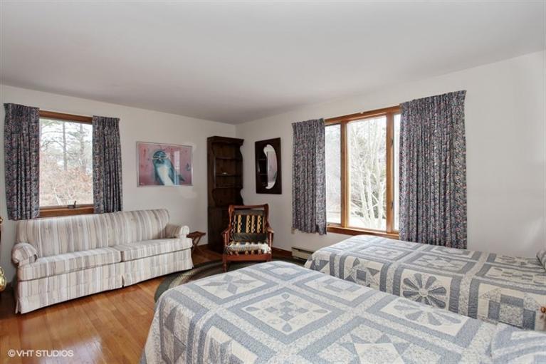 1020 Samoset Road Eastham, MA 02642 - Photo 10 of 16 a bedroom with two beds and a couch with window