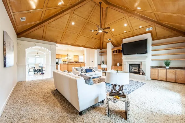 a living room with fireplace furniture and a flat screen tv