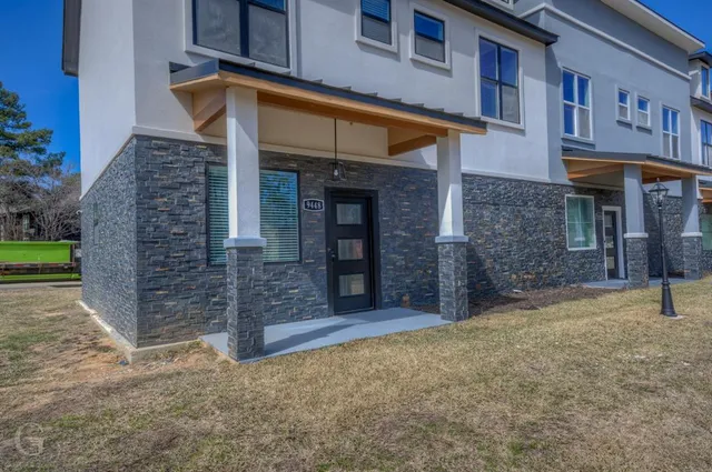 a view of a brick building with many windows