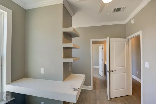 an empty room with wooden floor and closet