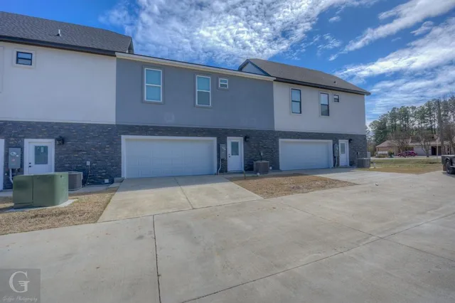 a front view of a house with a yard and a garage