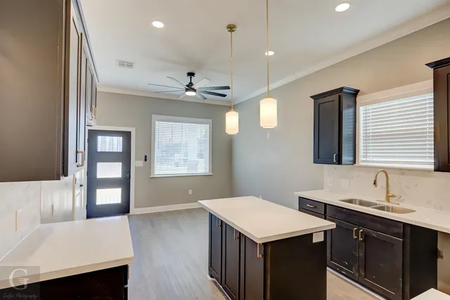 a bathroom with a sink a vanity and a large mirror