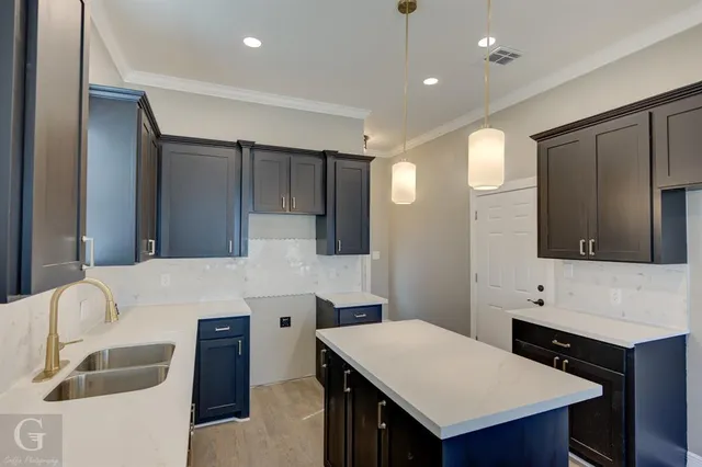 a kitchen with a stove refrigerator and cabinets