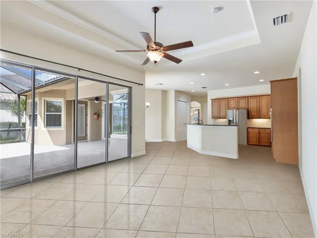 a view of a kitchen with a sink and an empty room