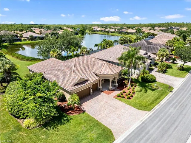 an aerial view of a house with a garden and lake view