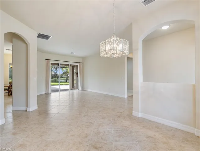 an empty room with windows and entrance