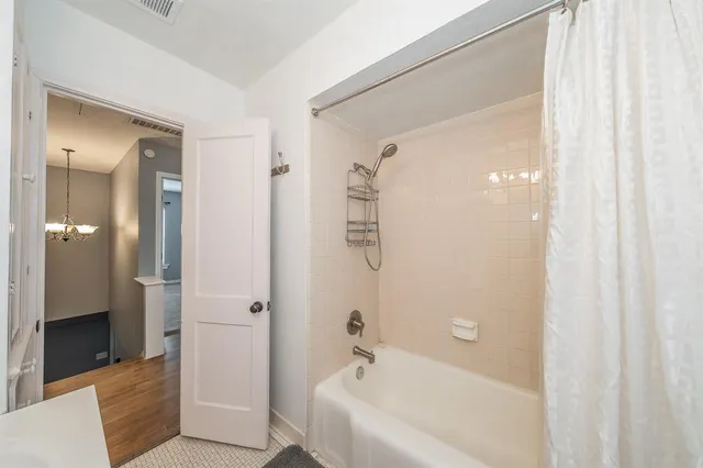 a bathroom with a bathtub and a shower