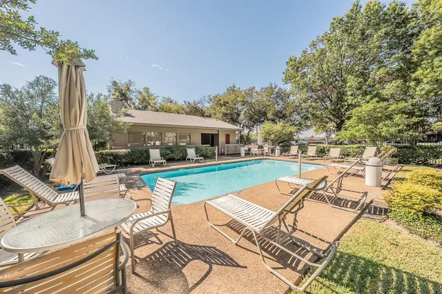 swimming pool view with a seating space