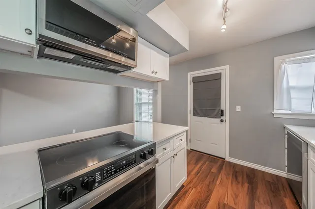 a kitchen with a stove and a refrigerator