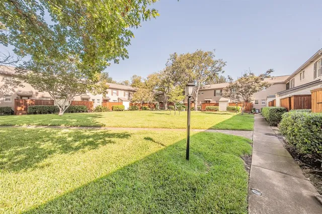 a view of yard with swimming pool and green space